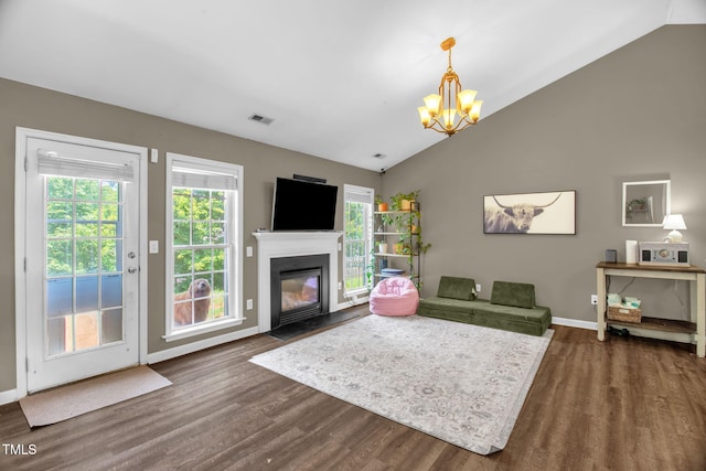 6001 Black Willow Dr, Greensboro, NC 27405 - living area featuring vaulted ceiling, a chandelier, dark wood-style floors, and a fireplace with flush hearth