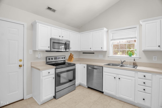 6001 Black Willow Dr, Greensboro, NC 27405 - kitchen with stainless steel appliances, lofted ceiling, white cabinets, and light countertops