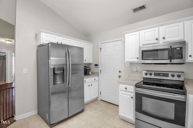 6001 Black Willow Dr, Greensboro, NC 27405 - kitchen with appliances with stainless steel finishes, light countertops, lofted ceiling, and white cabinetry