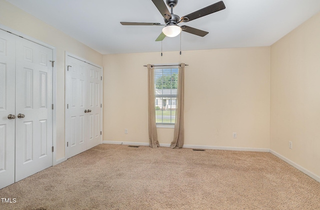 16 Emily Ct, Newton Grove, NC 28366 - unfurnished bedroom featuring multiple closets, carpet floors, and ceiling fan