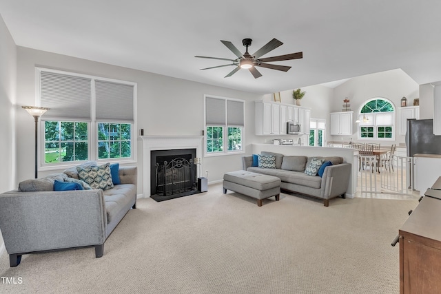 13201 Townfield Dr, Raleigh, NC 27614 - living area featuring ceiling fan, light carpet, a fireplace with flush hearth, and vaulted ceiling