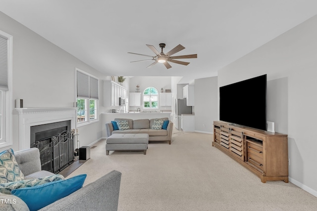13201 Townfield Dr, Raleigh, NC 27614 - living area with ceiling fan, light colored carpet, and a fireplace with flush hearth