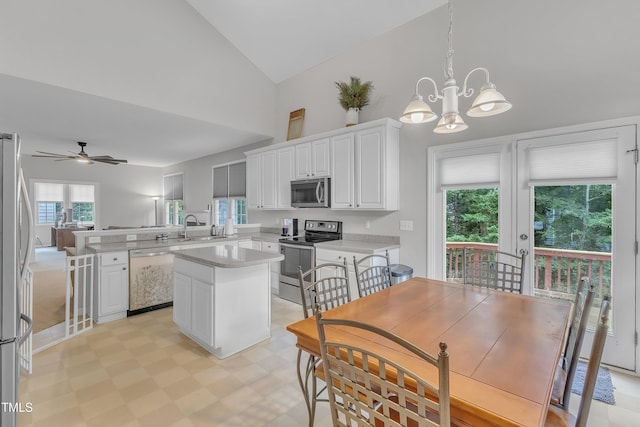 13201 Townfield Dr, Raleigh, NC 27614 - kitchen featuring appliances with stainless steel finishes, a peninsula, a chandelier, a center island, and white cabinetry