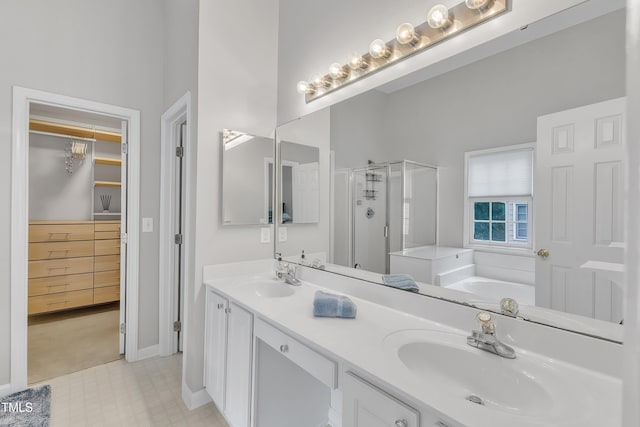 13201 Townfield Dr, Raleigh, NC 27614 - full bathroom featuring a stall shower, a garden tub, double vanity, a walk in closet, and tile patterned floors