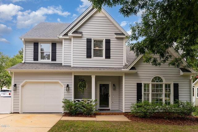 5609 Edgebury Rd, Raleigh, NC 27613 - view of front of home featuring a garage, a porch, and roof with shingles
