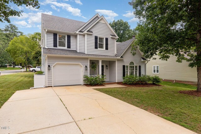 5609 Edgebury Rd, Raleigh, NC 27613 - view of front facade featuring a front yard, roof with shingles, a garage, and driveway