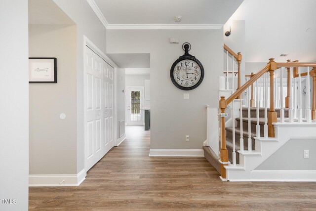 5609 Edgebury Rd, Raleigh, NC 27613 - hall with wood finished floors, stairs, and ornamental molding