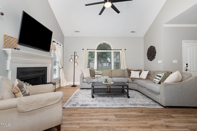 5609 Edgebury Rd, Raleigh, NC 27613 - living room with a ceiling fan, wood finished floors, a fireplace, and high vaulted ceiling