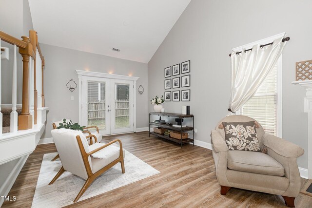 5609 Edgebury Rd, Raleigh, NC 27613 - living area featuring stairway, high vaulted ceiling, light wood finished floors, and french doors
