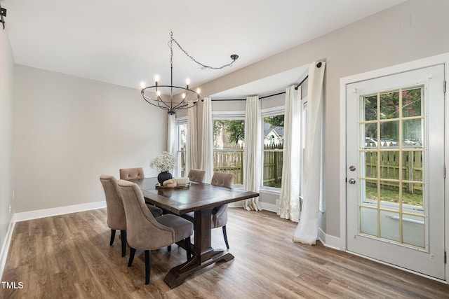 5609 Edgebury Rd, Raleigh, NC 27613 - dining room with a chandelier, healthy amount of natural light, and wood finished floors