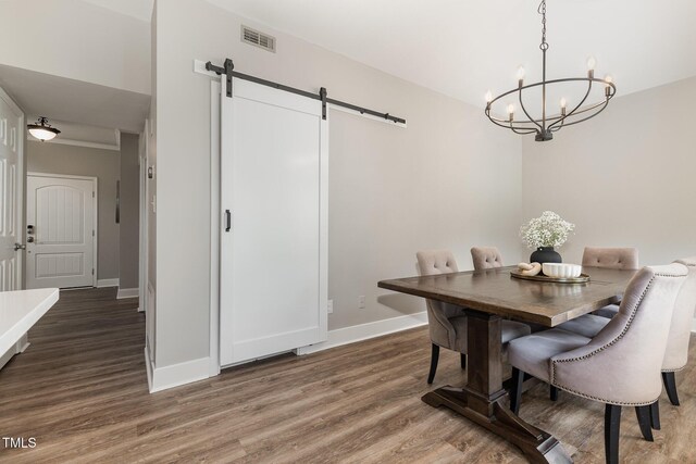 5609 Edgebury Rd, Raleigh, NC 27613 - dining room featuring a barn door, a chandelier, and wood finished floors