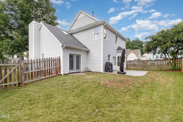 5609 Edgebury Rd, Raleigh, NC 27613 - rear view of house with a patio area, a fenced backyard, a chimney, and a shingled roof