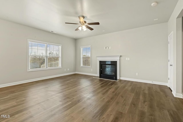 245 E Webber Ln, Clayton, NC 27527 - unfurnished living room with a ceiling fan, a glass covered fireplace, and dark wood-style flooring