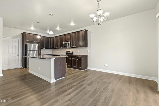 245 E Webber Ln, Clayton, NC 27527 - kitchen with stainless steel appliances, wood finished floors, a chandelier, and tasteful backsplash