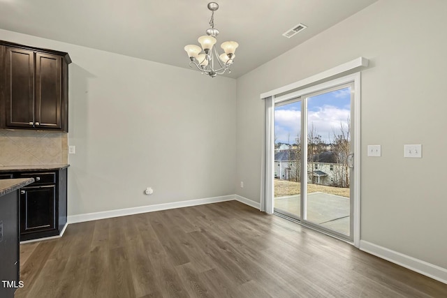 245 E Webber Ln, Clayton, NC 27527 - unfurnished dining area with dark wood-style flooring and a chandelier