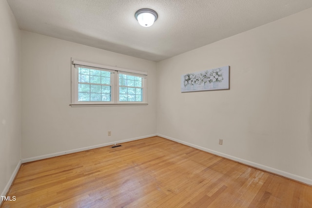 906 Cindy St, Cary, NC 27511 - empty room with light wood-type flooring and a textured ceiling
