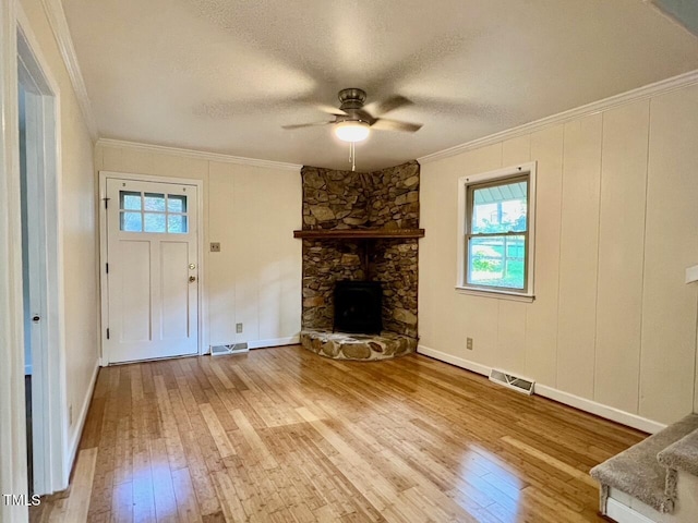 612 Williamsboro St, Oxford, NC 27565 - unfurnished living room with light wood finished floors, ornamental molding, a ceiling fan, a stone fireplace, and a textured ceiling