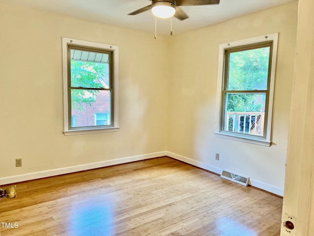 612 Williamsboro St, Oxford, NC 27565 - empty room with healthy amount of natural light, ceiling fan, and hardwood / wood-style floors
