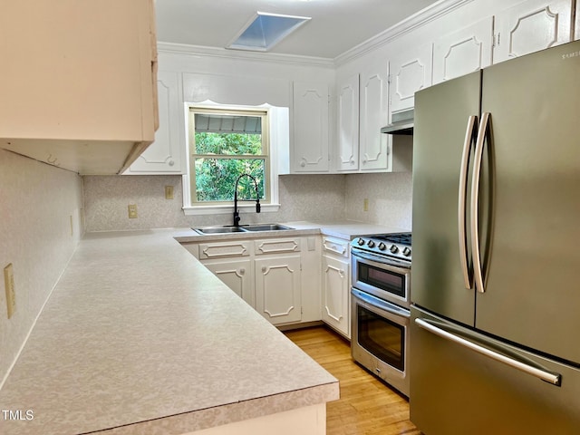 612 Williamsboro St, Oxford, NC 27565 - kitchen with appliances with stainless steel finishes, white cabinets, light countertops, crown molding, and tasteful backsplash
