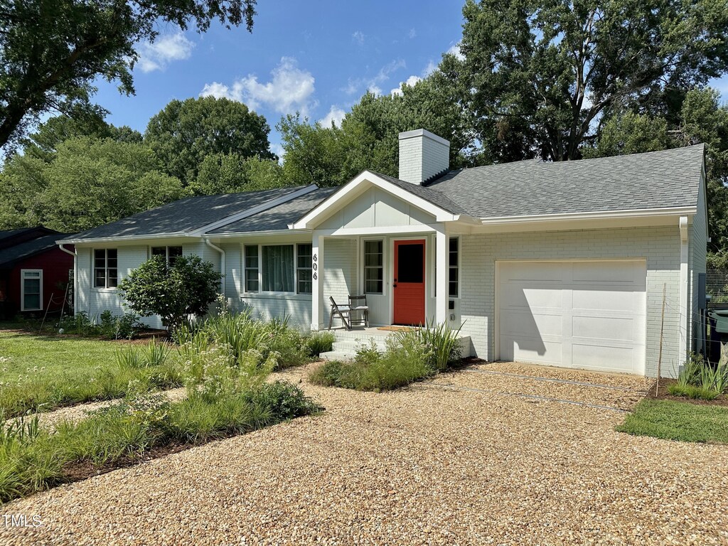 606 Hillsborough Rd, Carrboro, NC 27510 - ranch-style house featuring an attached garage, a chimney, a porch, and brick siding