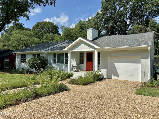 606 Hillsborough Rd, Carrboro, NC 27510 - ranch-style house featuring an attached garage, a chimney, a porch, and brick siding