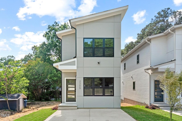 2205 Tampa Ave, Durham, NC 27705 - view of front of property featuring a shed, stucco siding, and a front lawn