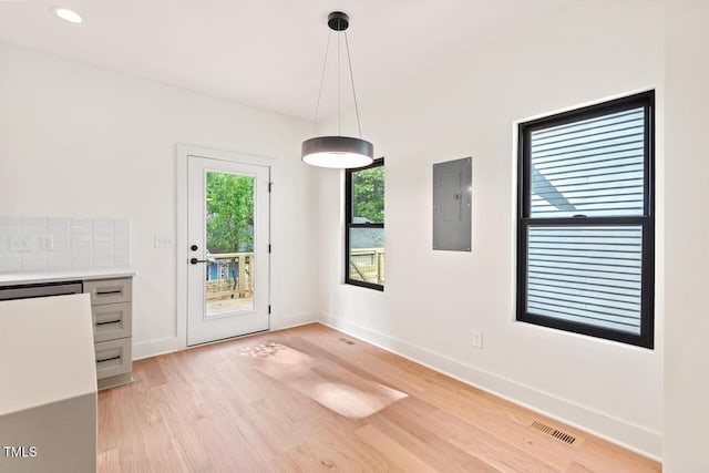 2205 Tampa Ave, Durham, NC 27705 - unfurnished dining area featuring electric panel and light wood-type flooring