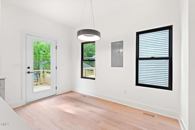 2205 Tampa Ave, Durham, NC 27705 - unfurnished dining area featuring electric panel and light wood finished floors