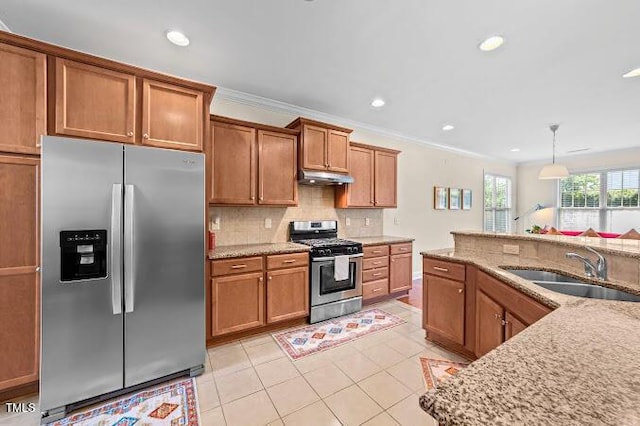 4007 Strendal Dr, Cary, NC 27519 - kitchen featuring stainless steel appliances, under cabinet range hood, brown cabinetry, light tile patterned floors, and light stone counters