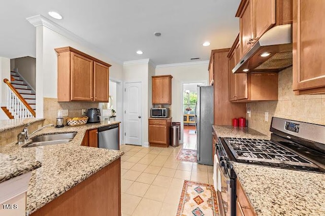 4007 Strendal Dr, Cary, NC 27519 - kitchen with appliances with stainless steel finishes, under cabinet range hood, light stone counters, ornamental molding, and tasteful backsplash