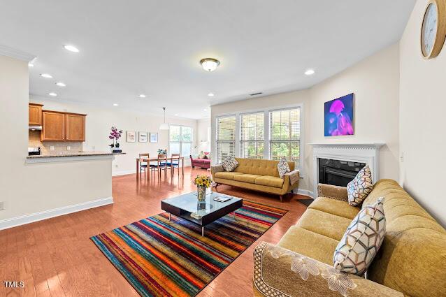 4007 Strendal Dr, Cary, NC 27519 - living area featuring wood finished floors, recessed lighting, and a fireplace