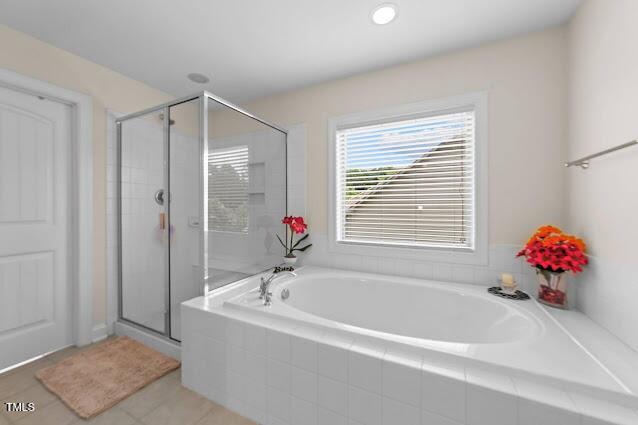 4007 Strendal Dr, Cary, NC 27519 - full bathroom featuring a garden tub, a stall shower, and tile patterned flooring