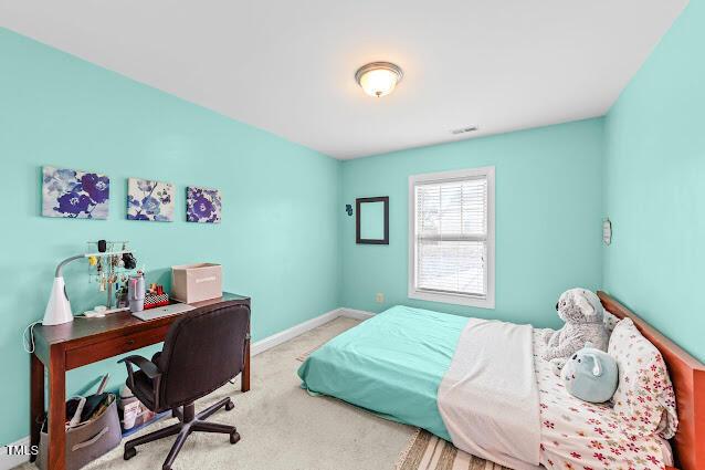 4007 Strendal Dr, Cary, NC 27519 - carpeted bedroom featuring baseboards and a desk