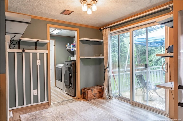 1360 Rays Bridge Rd, Whispering Pines, NC 28327 - laundry room with washing machine and dryer, wood finished floors, a textured ceiling, and crown molding