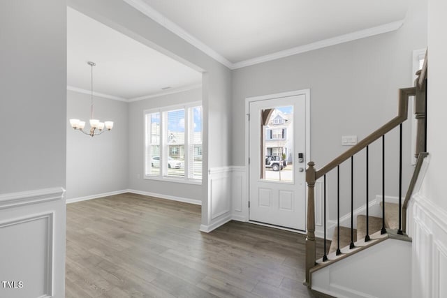 1409 Jasmine View Way, Knightdale, NC 27545 - entrance foyer featuring wood finished floors, a chandelier, ornamental molding, and stairway