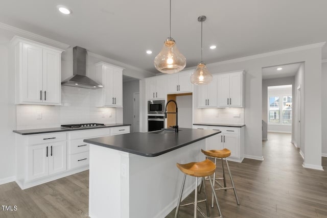 1409 Jasmine View Way, Knightdale, NC 27545 - kitchen featuring wall chimney exhaust hood, appliances with stainless steel finishes, dark countertops, wood finished floors, and recessed lighting
