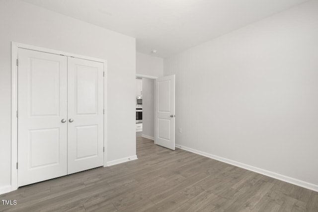 1409 Jasmine View Way, Knightdale, NC 27545 - unfurnished bedroom with wood finished floors and a closet