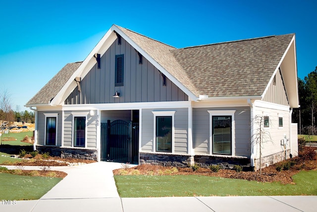 1409 Jasmine View Way, Knightdale, NC 27545 - modern farmhouse style home with board and batten siding, roof with shingles, and stone siding