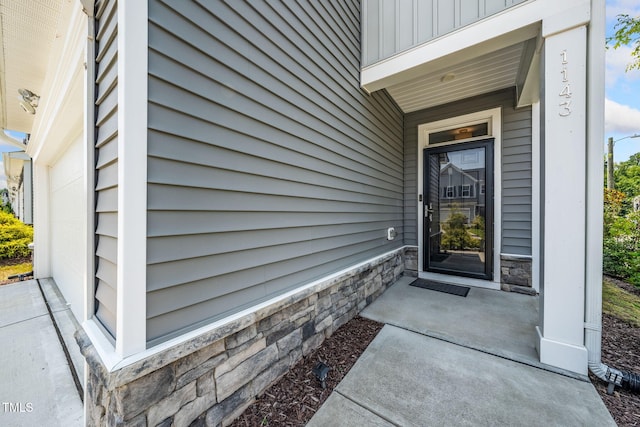 1143 Sweet Cream Ct, Durham, NC 27703 - property entrance featuring stone siding and board and batten siding