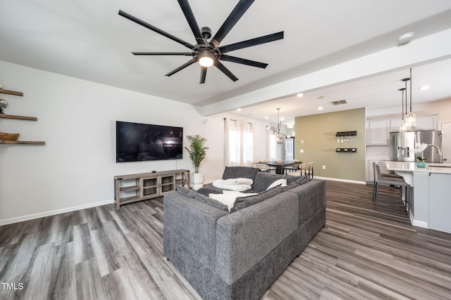 1143 Sweet Cream Ct, Durham, NC 27703 - living area featuring wood finished floors, a ceiling fan, a chandelier, and recessed lighting