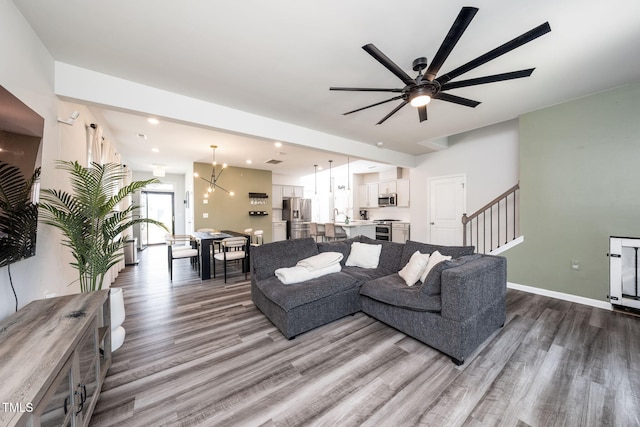 1143 Sweet Cream Ct, Durham, NC 27703 - living area with wood finished floors, a ceiling fan, stairs, and recessed lighting