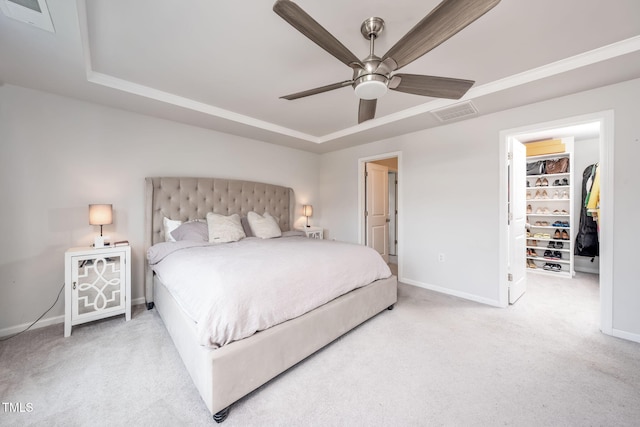1143 Sweet Cream Ct, Durham, NC 27703 - carpeted bedroom featuring a raised ceiling, a walk in closet, and a ceiling fan