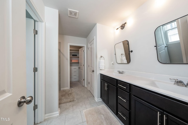 1143 Sweet Cream Ct, Durham, NC 27703 - full bathroom featuring double vanity, a walk in closet, and tile patterned flooring