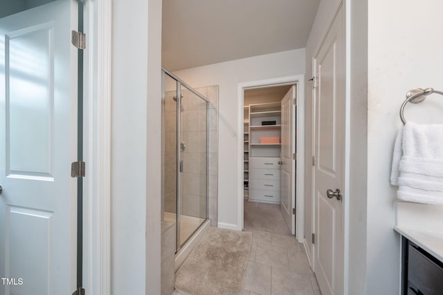 1143 Sweet Cream Ct, Durham, NC 27703 - bathroom featuring a stall shower, a spacious closet, tile patterned floors, and vanity