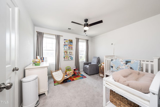 1143 Sweet Cream Ct, Durham, NC 27703 - bedroom featuring light carpet, a crib, and ceiling fan