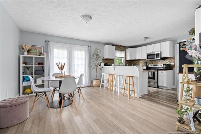 4450 Chesterbrook Dr, Fayetteville, NC 28314 - dining space featuring light wood finished floors and a textured ceiling