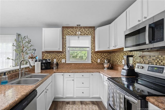 4450 Chesterbrook Dr, Fayetteville, NC 28314 - kitchen featuring stainless steel appliances, white cabinetry, backsplash, and dark wood-type flooring