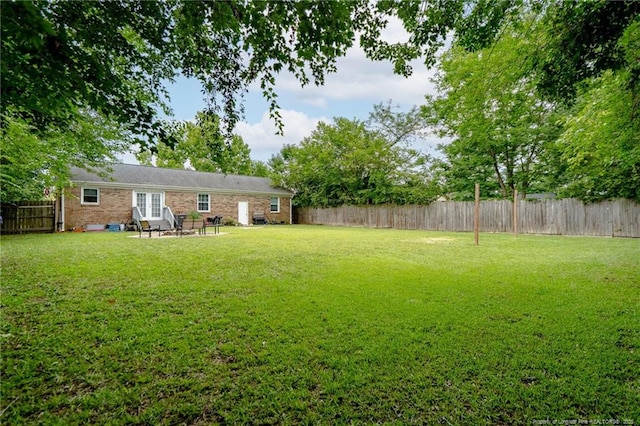 4450 Chesterbrook Dr, Fayetteville, NC 28314 - fenced backyard featuring a patio area and french doors