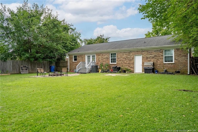 4450 Chesterbrook Dr, Fayetteville, NC 28314 - back of property with brick siding, an outdoor fire pit, french doors, and a patio area