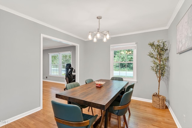 213 SE Maynard Rd, Cary, NC 27511 - dining area with a chandelier, light wood-type flooring, and crown molding